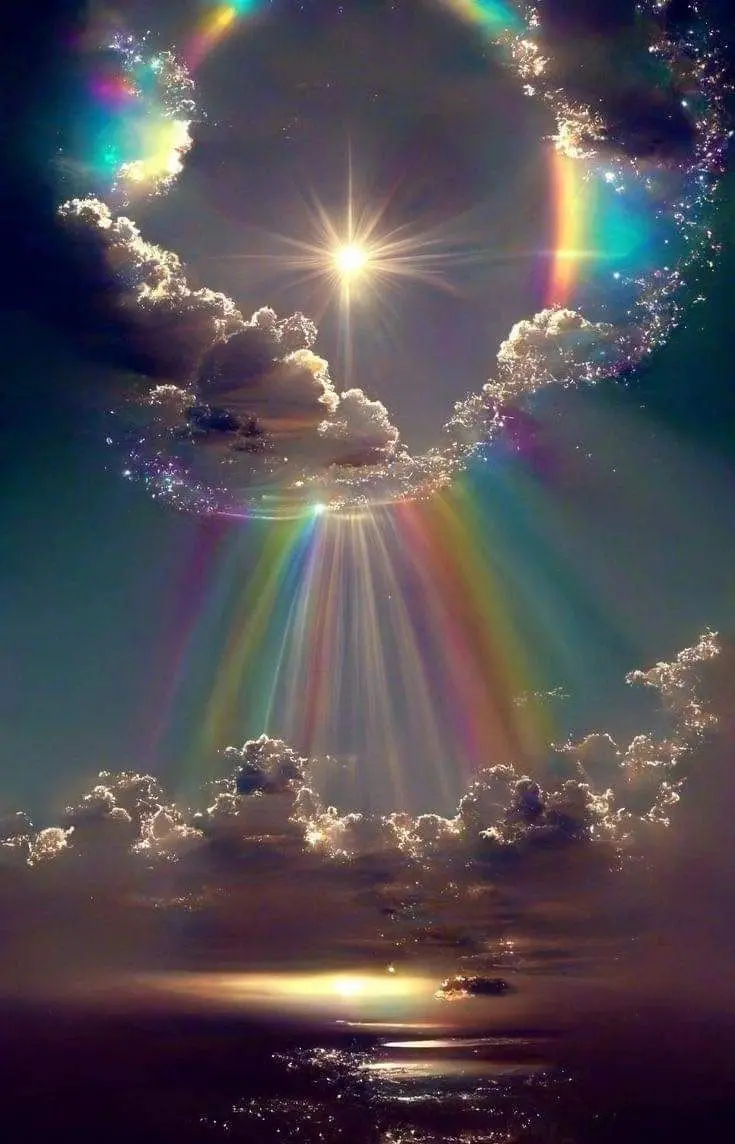 A rainbow is seen in the sky above clouds.